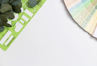 Interior design workspace with stencil, eucalyptus, and color swatches