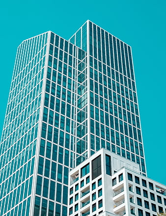 Modern Glass Skyscraper Against Vibrant Teal Sky