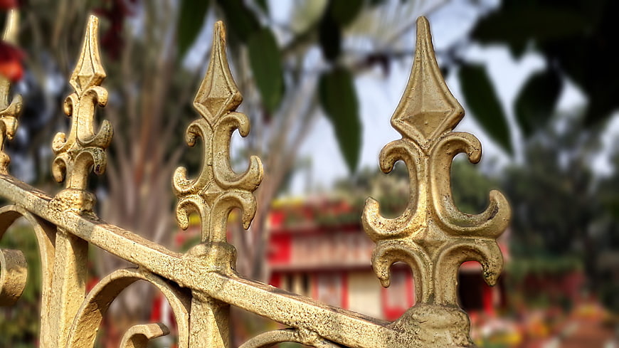 Close-up of ornate golden temple gate finials