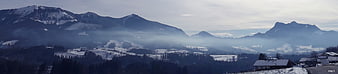 Panoramic winter mountain landscape with snow and mist