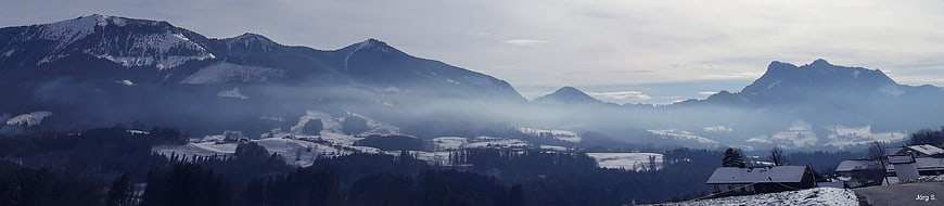 Panoramic winter mountain landscape with snow and mist