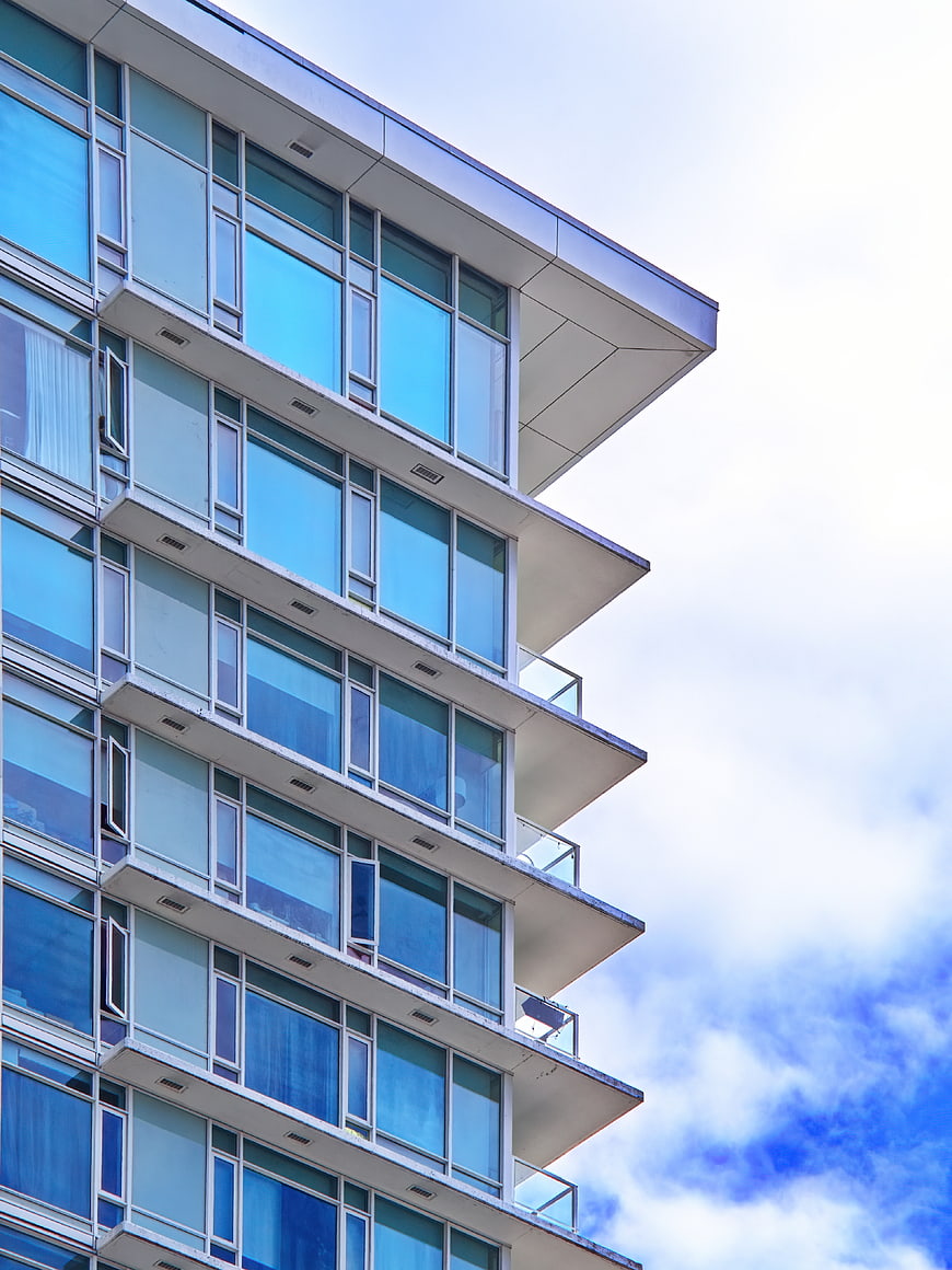 Modern Glass Apartment Building with Blue Windows