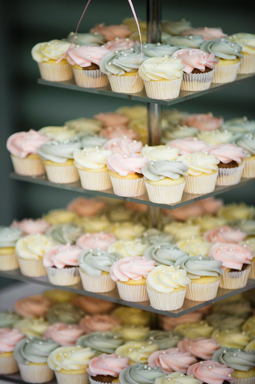 Pastel Frosted Cupcakes on Multi-Tiered Glass Display Stand