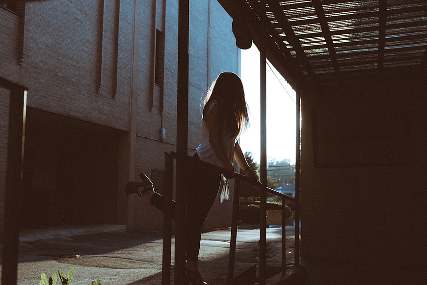 Silhouette of Woman Stretching on Staircase in Sunlight