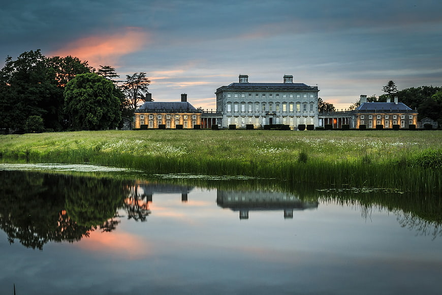 Grand Georgian Estate Reflected in Lake at Sunset