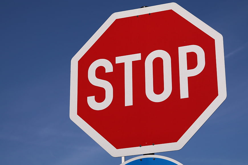 Red Stop Sign Against Clear Blue Sky