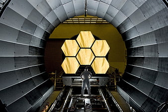 Astronomer Standing Before Space Telescope Mirror Assembly in Cleanroom