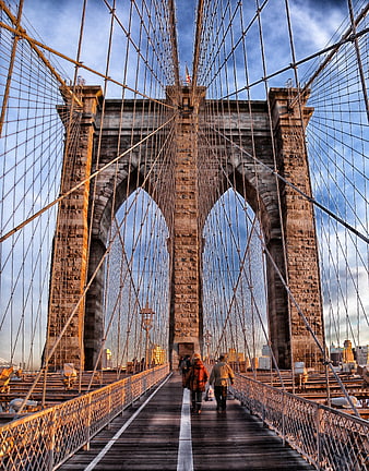 Brooklyn Bridge Walkway at Golden Hour with Pedestrians