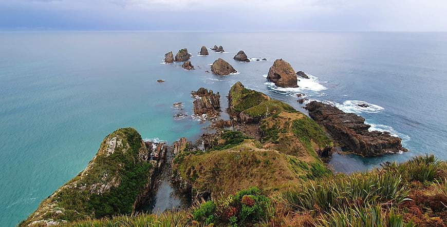 Dramatic coastal landscape with rocky sea stacks and turquoise ocean