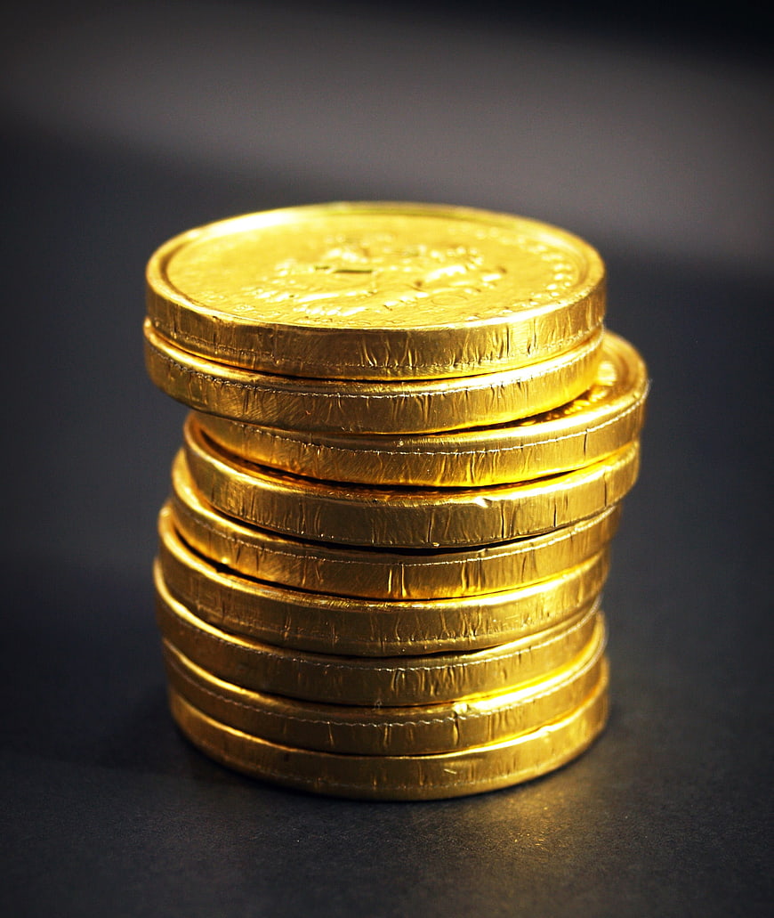 Stack of gold coins on dark background