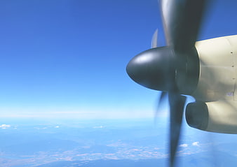 Airplane Propeller in Flight Against Blue Sky