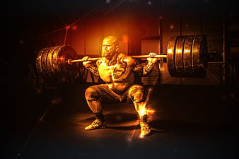 Muscular man performing a heavy barbell squat in a dark gym