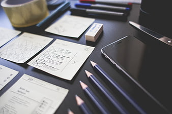 UX Design Workspace with Wireframes and Smartphone