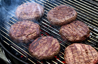 Sizzling Burger Patties Grilling on Charcoal BBQ