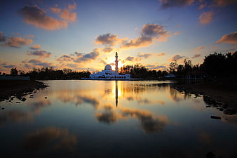 White Mosque Reflection at Sunset Over Calm Water