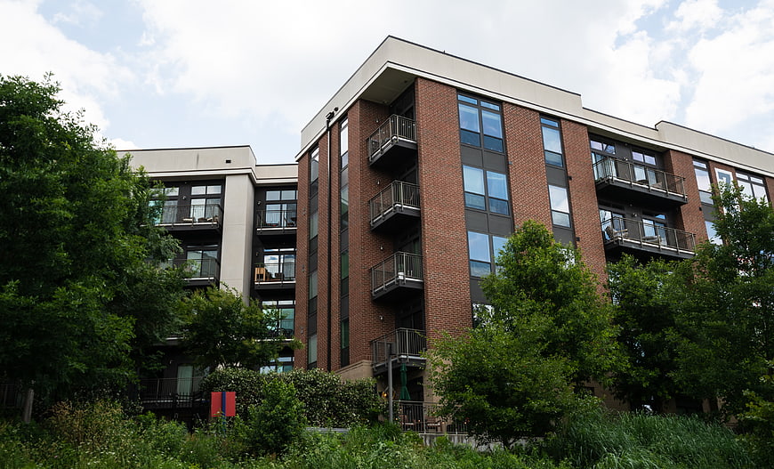 Modern Brick Apartment Building with Balconies and Trees