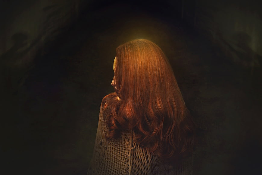 Mysterious Redhead Woman in Dark Moody Atmosphere