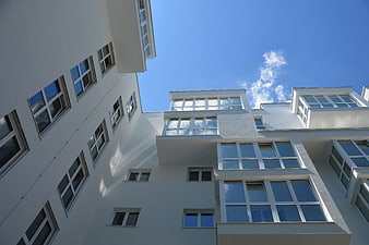 Low angle view of modern white apartment building facade