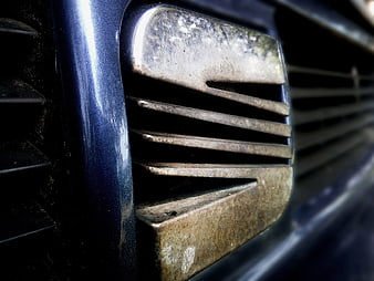 Close-up of vintage Seat car emblem on blue vehicle