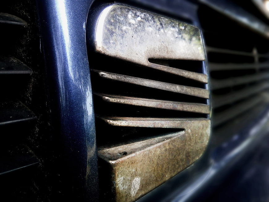 Close-up of vintage Seat car emblem on blue vehicle