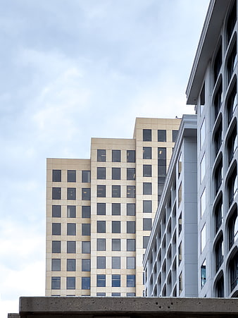 Modern Office Buildings with Geometric Windows and Blue Sky