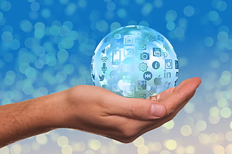 Hand holding digital globe with social media icons