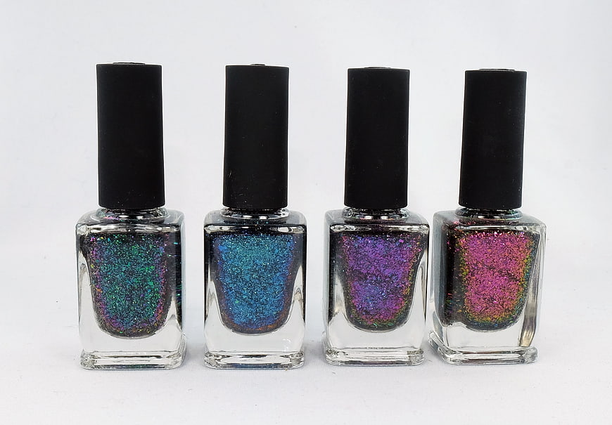 Four bottles of colorful glitter nail polish on white background