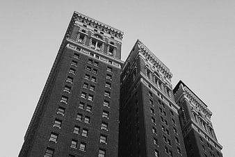 Low angle black and white view of historic skyscrapers