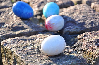 Colored Easter Eggs on Rough Stone Wall
