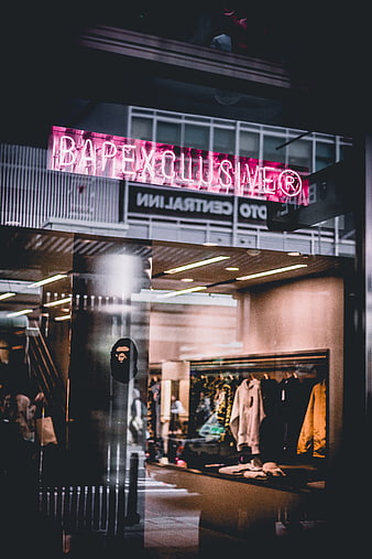 Neon BAPE Exclusive Storefront at Night with Reflections