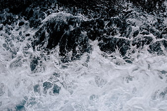 Aerial View of Turbulent Ocean Waves and Sea Foam
