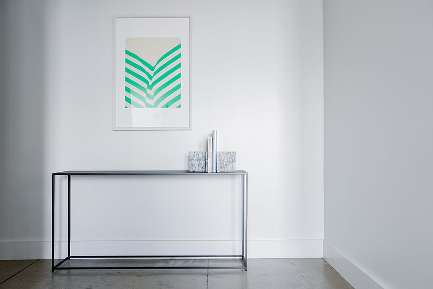 Minimalist interior with console table and abstract art