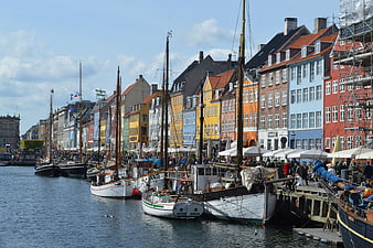 Colorful historic buildings and boats at Nyhavn harbor Copenhagen