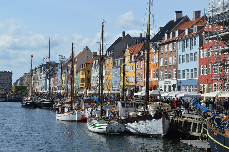 Colorful historic buildings and boats at Nyhavn harbor Copenhagen