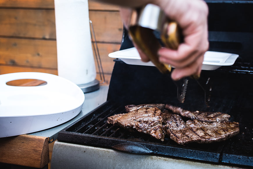 Grilling Beef Steaks on Outdoor BBQ Grill