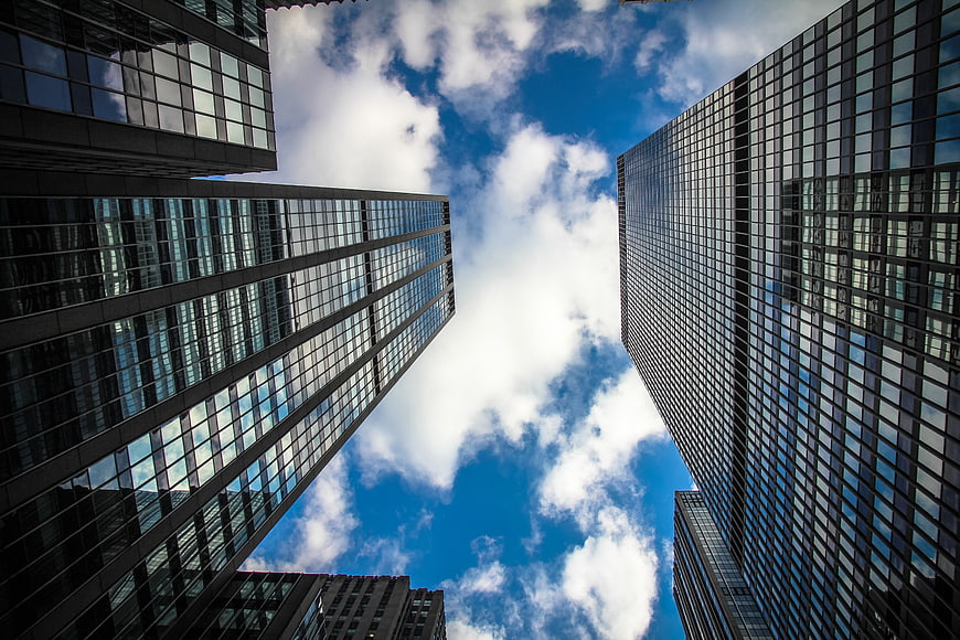 Low angle view of modern skyscrapers against blue sky