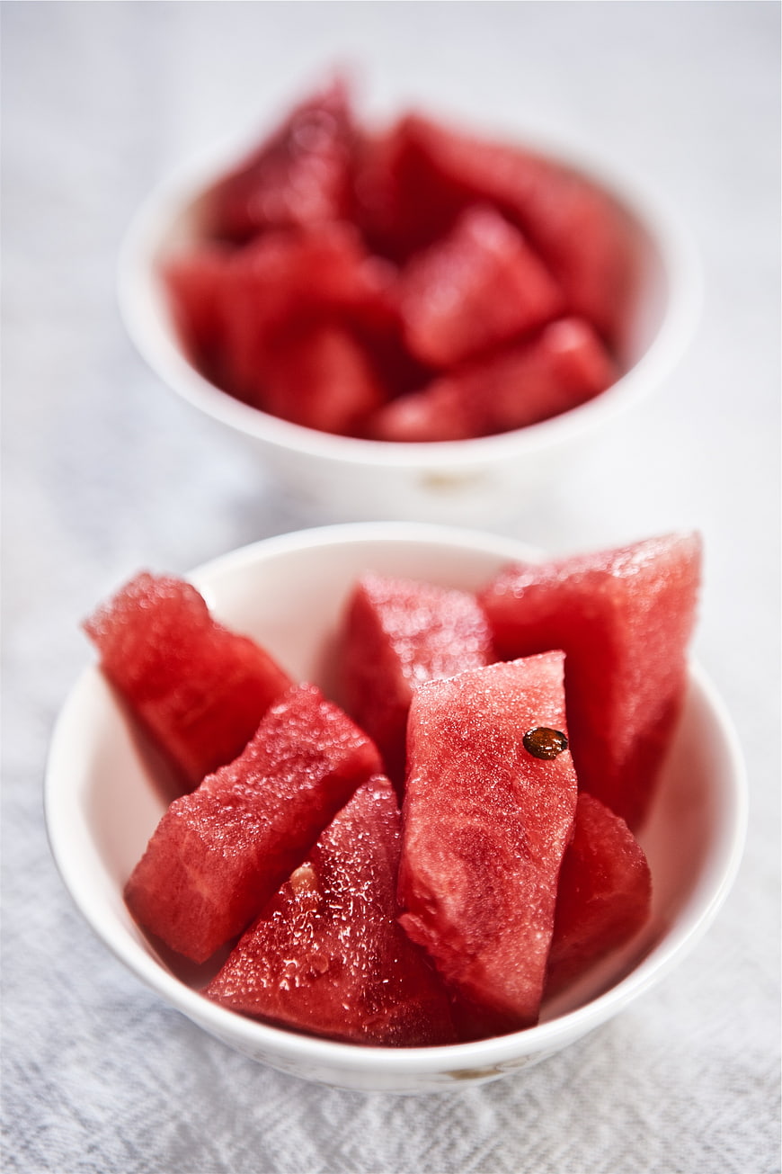 Fresh Watermelon Cubes in White Bowls on Marble
