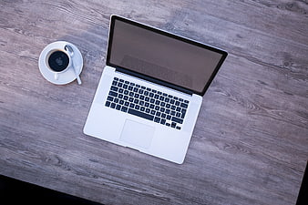 Top View of Laptop and Coffee on Wooden Desk