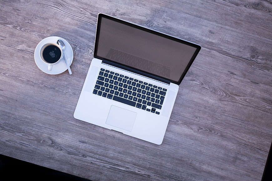 Top View of Laptop and Coffee on Wooden Desk