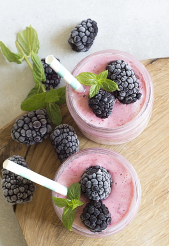 Overhead view of frozen blackberry smoothies in glass jars