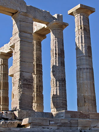 Ancient Greek Temple Columns Against Clear Blue Sky