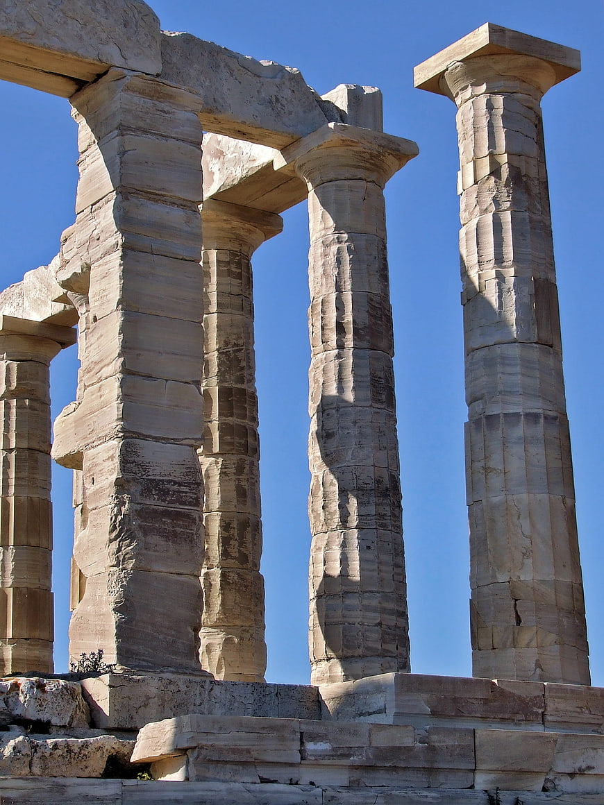 Ancient Greek Temple Columns Against Clear Blue Sky