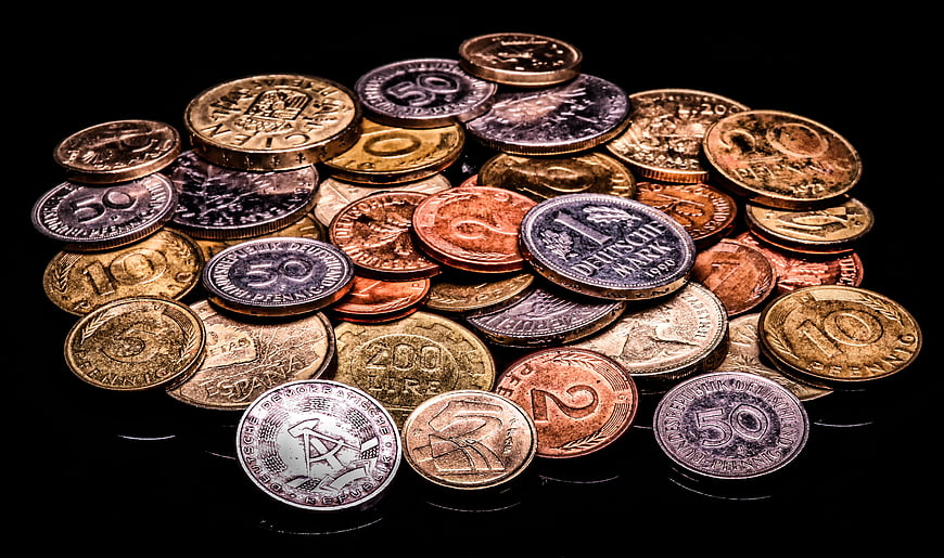Collection of vintage European coins on a black background