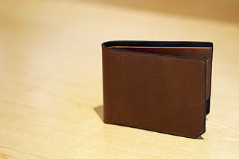 Brown Leather Wallet on Wooden Table