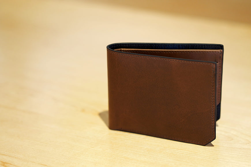 Brown Leather Wallet on Wooden Table