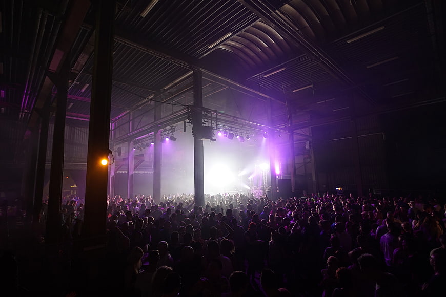 Crowded Music Concert in Industrial Warehouse Venue
