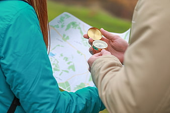 Couple Using Compass and Map for Hiking Navigation