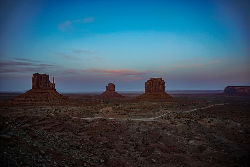 Monument Valley buttes at twilight with winding desert road