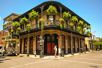 Historic New Orleans Corner Building with Balcony and Ferns