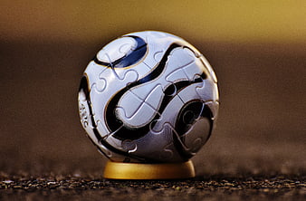 Close-up of a white and black soccer ball on a stand
